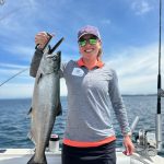 Customer holding a king salmon caught during a Lake Michigan fishing charter near Traverse City