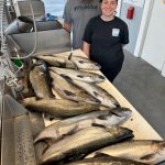 Couple with a limit of king salmon after a successful Lake Michigan fishing charter near Traverse City