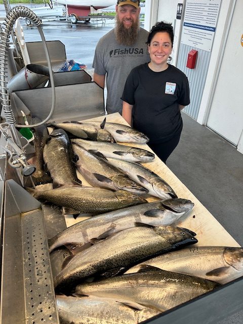 Couple with a limit of king salmon after a successful Lake Michigan fishing charter near Traverse City